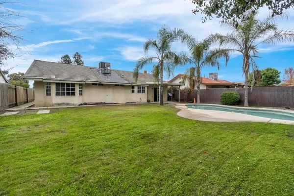 a view of a swimming pool with a yard