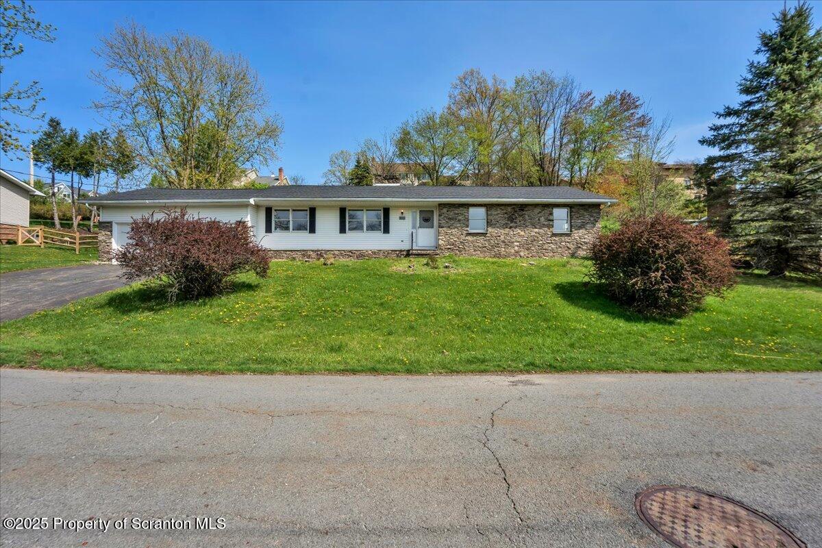 a view of a house with a yard and potted plants