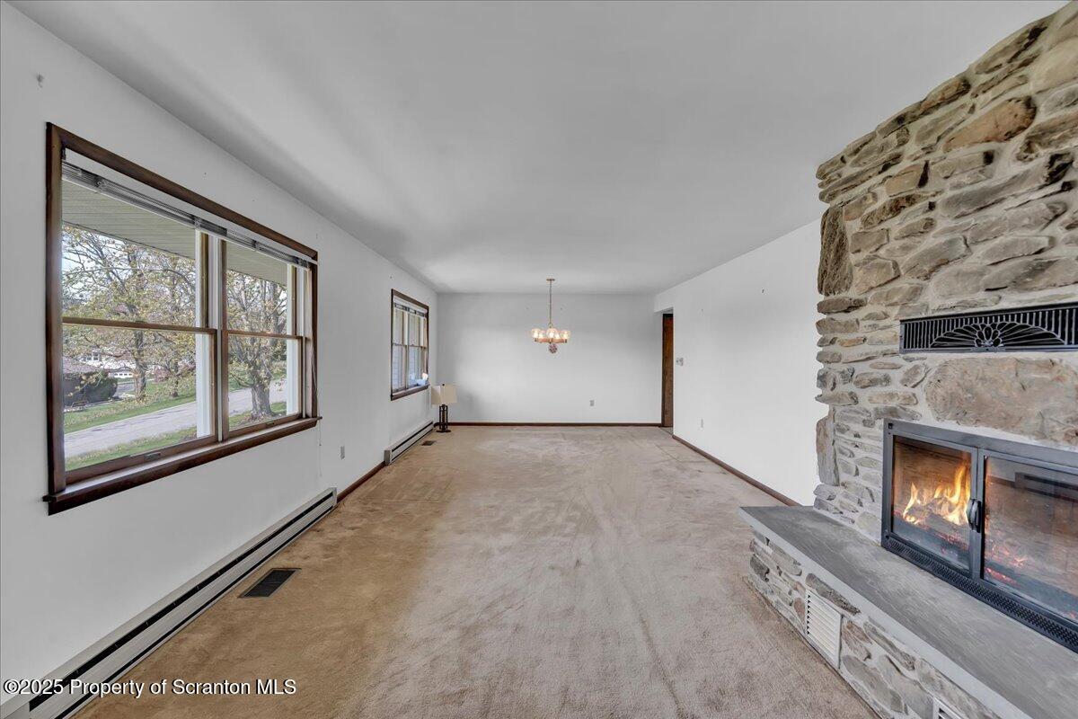 906 Violet Terrace Clarks Summit, PA 18411 - Photo 11 of 38 a view of an empty room with a fireplace and a window
