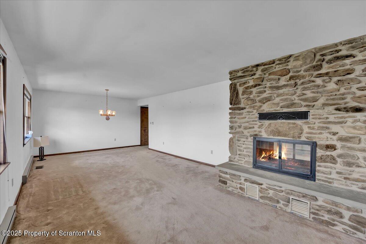 906 Violet Terrace Clarks Summit, PA 18411 - Photo 12 of 38 a view of empty room with a fireplace