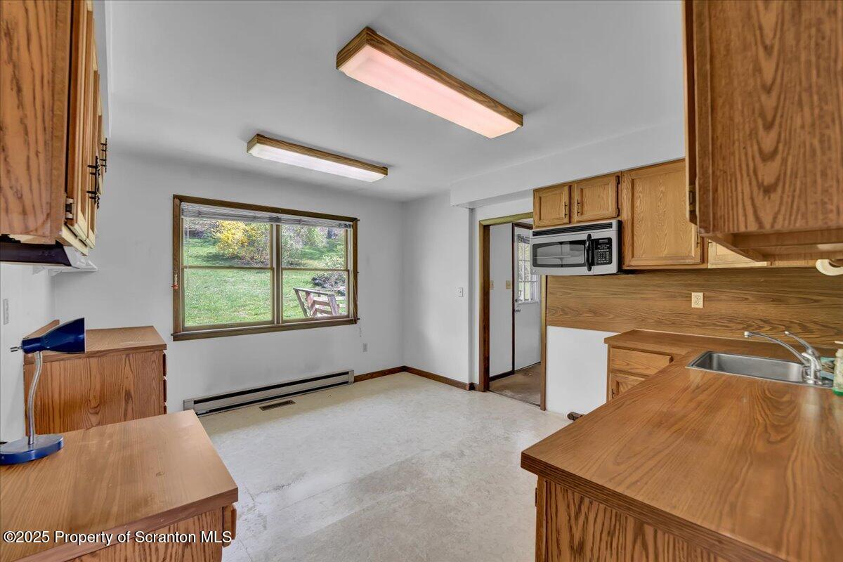 906 Violet Terrace Clarks Summit, PA 18411 - Photo 15 of 38 a view of a kitchen with furniture and a window