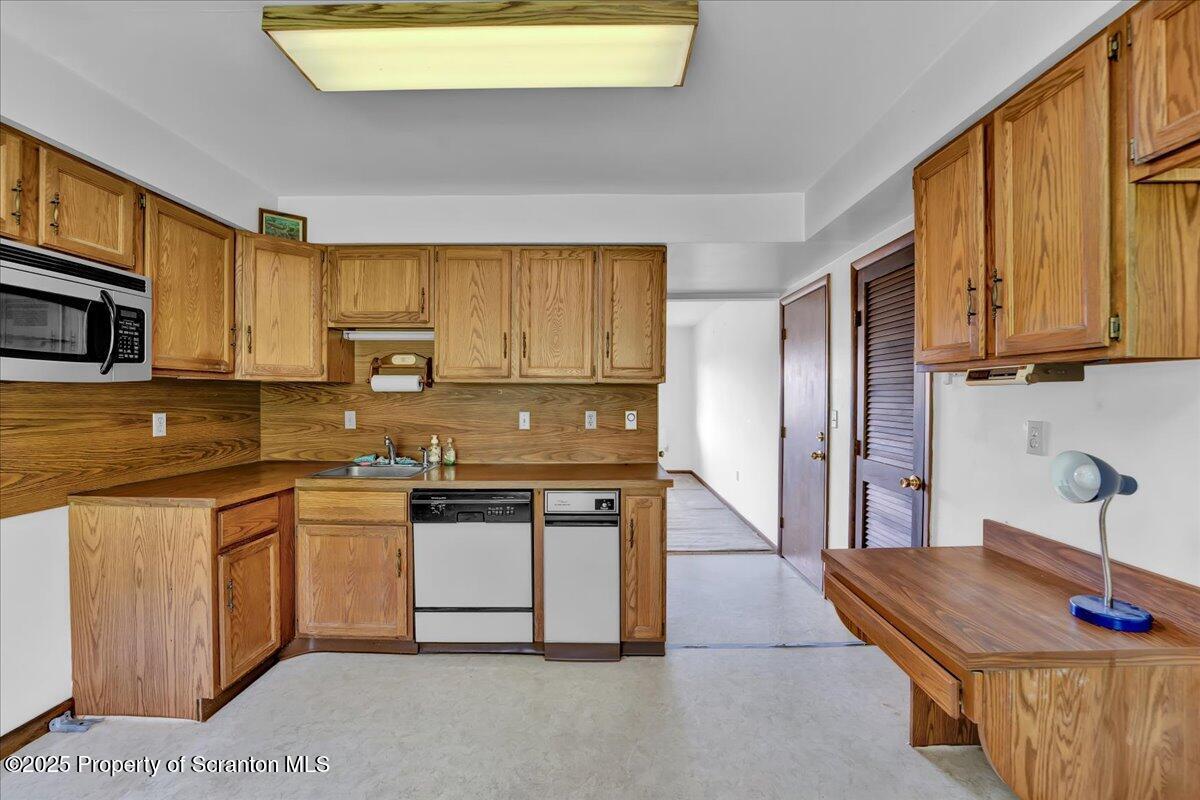 906 Violet Terrace Clarks Summit, PA 18411 - Photo 16 of 38 a kitchen with stainless steel appliances granite countertop a sink and a stove