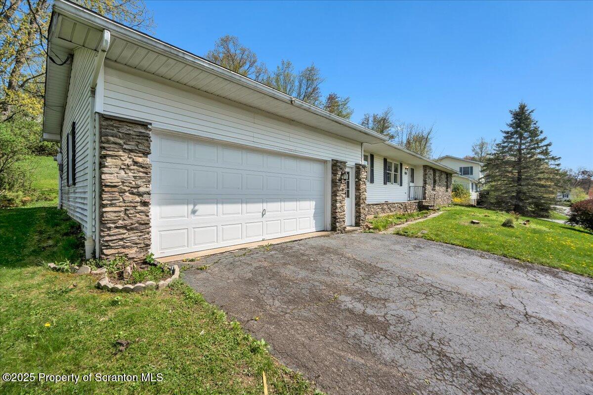 906 Violet Terrace Clarks Summit, PA 18411 - Photo 33 of 38 a front view of a house with a yard and garage