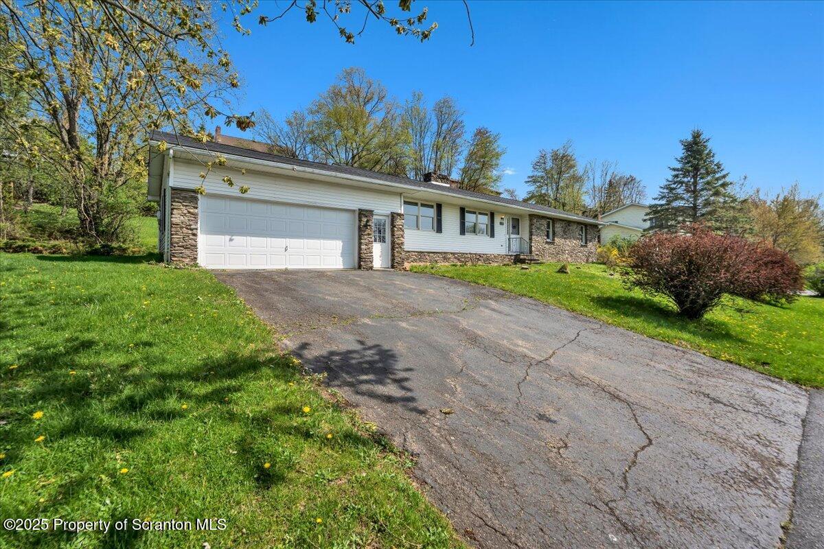 906 Violet Terrace Clarks Summit, PA 18411 - Photo 36 of 38 a front view of a house with a yard and a garage
