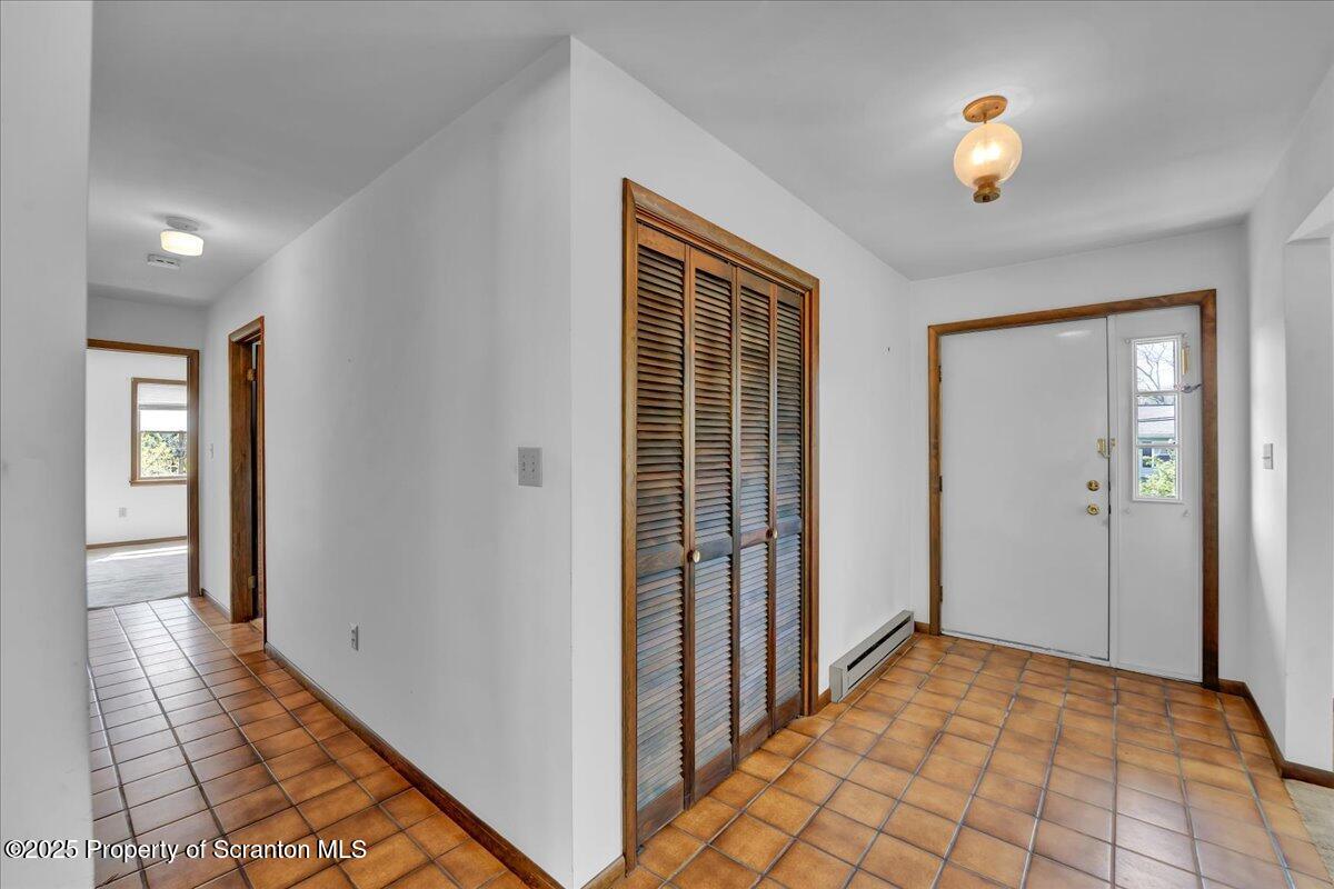 906 Violet Terrace Clarks Summit, PA 18411 - Photo 4 of 38 a view of a hallway with wooden floor and dining room