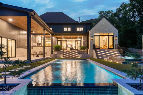 an aerial view of house with outdoor space and swimming pool