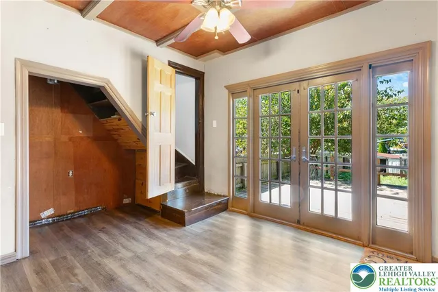 a view of a hallway with wooden floor and staircase