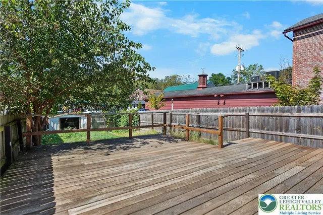 a view of backyard with seating area and green space