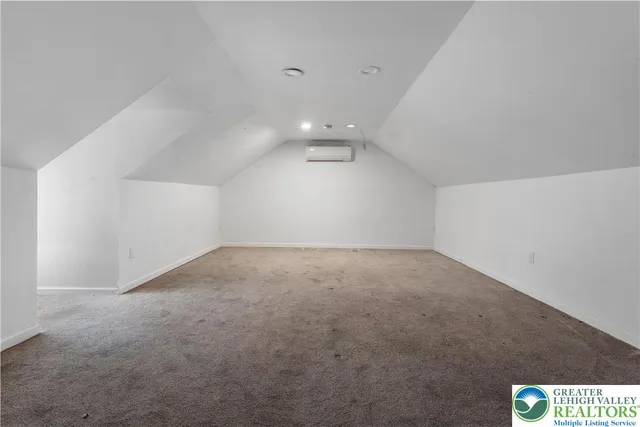 a bathroom with a white bath tub and a toilet