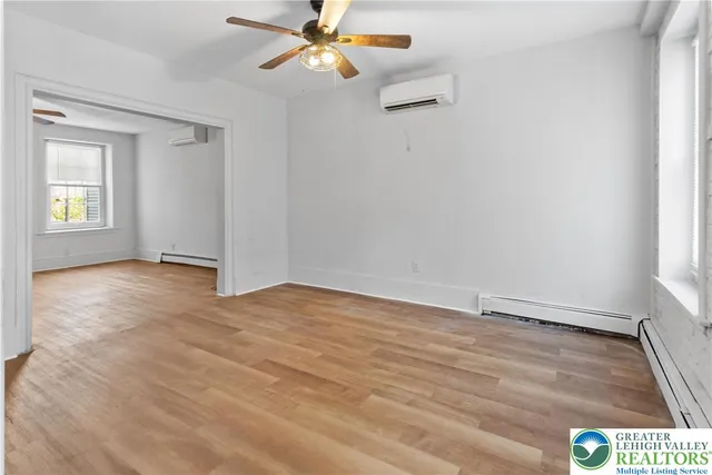a view of staircase with wooden floor and white walls