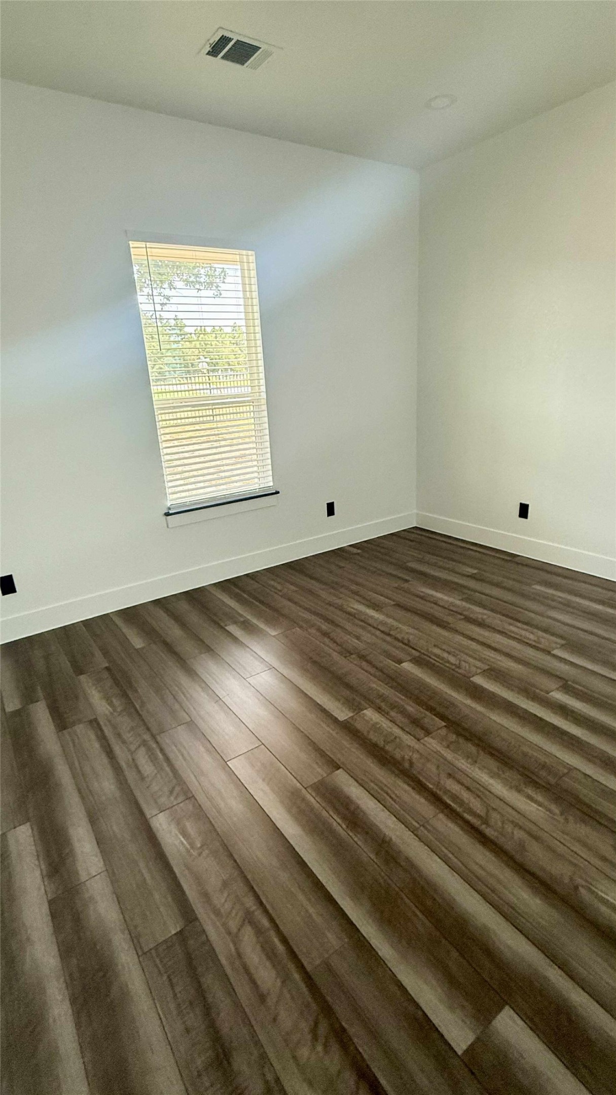 146 Buena Fortuna Road Elgin, TX 78621 - Photo 4 of 15 a view of an empty room with wooden floor and a window