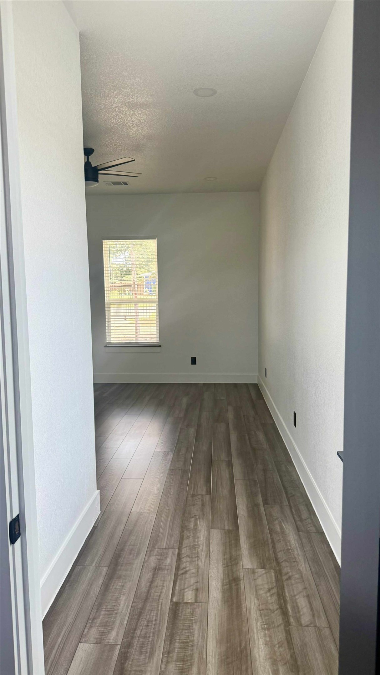 146 Buena Fortuna Road Elgin, TX 78621 - Photo 9 of 15 an empty room with wooden floor and windows