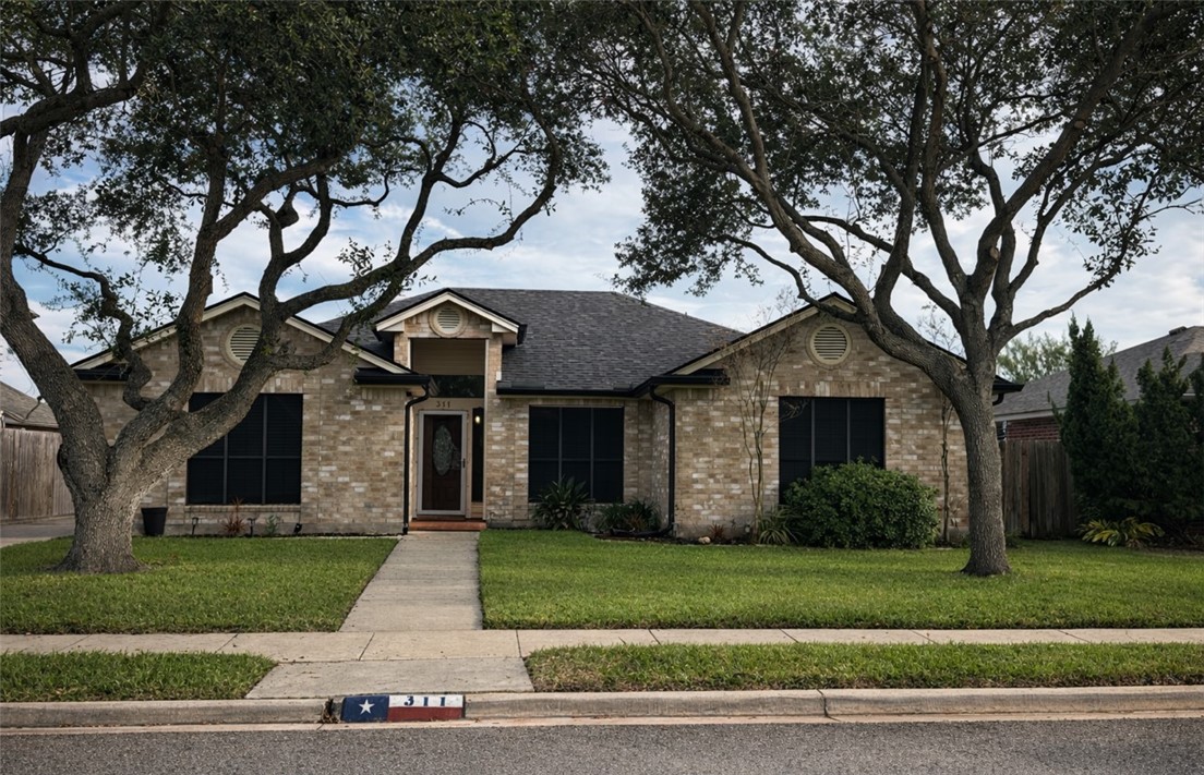 311 Blue Water Drive Portland, TX 78374 - Photo 1 of 25 a front view of house with a garden