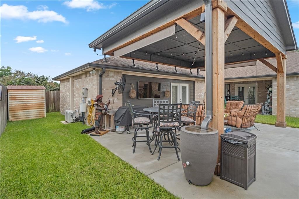 311 Blue Water Drive Portland, TX 78374 - Photo 25 of 25 a view of a patio with table and chairs and a barbeque
