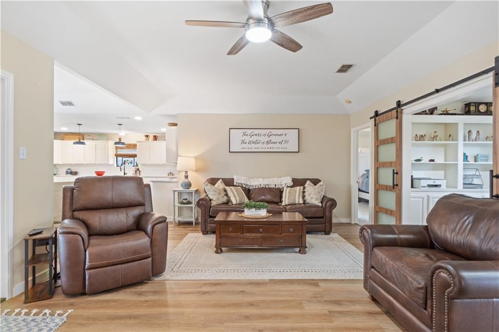 311 Blue Water Drive Portland, TX 78374 - Photo 3 of 25 a living room with furniture and a wooden floor