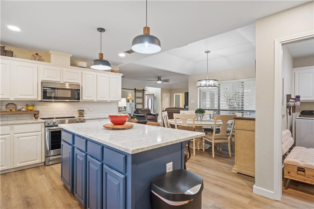 311 Blue Water Drive Portland, TX 78374 - Photo 8 of 25 a kitchen with a table chairs stove and microwave