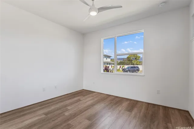an empty room with a window and wooden floor