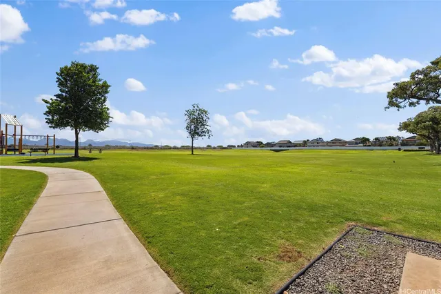 a view of yard with swimming pool and green space
