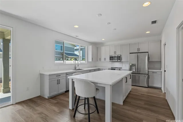 a kitchen with a stove a refrigerator and a sink
