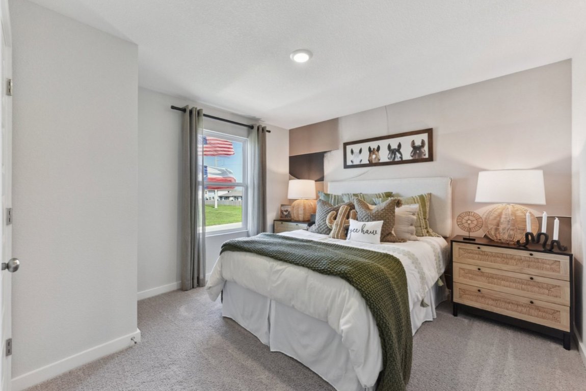 10604 Justify Lane Buda, TX 78610 - Photo 10 of 19 a bedroom with a bed and a window