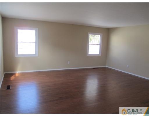 12 Indiana Road Somerset, NJ 08873 - Photo 2 of 12 an empty room with wooden floor and windows