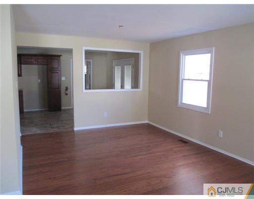 12 Indiana Road Somerset, NJ 08873 - Photo 3 of 12 a view of an empty room with wooden floor and a window