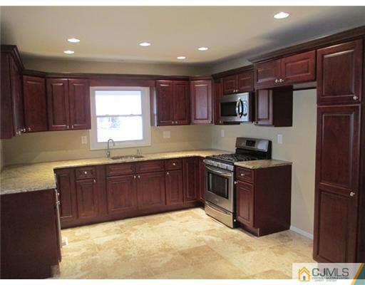 12 Indiana Road Somerset, NJ 08873 - Photo 4 of 12 a kitchen with stainless steel appliances granite countertop a stove a sink and a refrigerator
