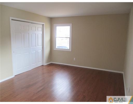12 Indiana Road Somerset, NJ 08873 - Photo 5 of 12 an empty room with wooden floor and windows