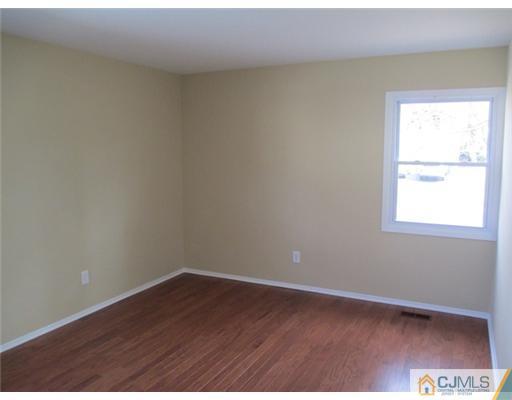12 Indiana Road Somerset, NJ 08873 - Photo 8 of 12 an empty room with wooden floor and windows