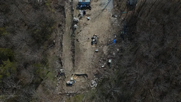 a view of a house with a forest