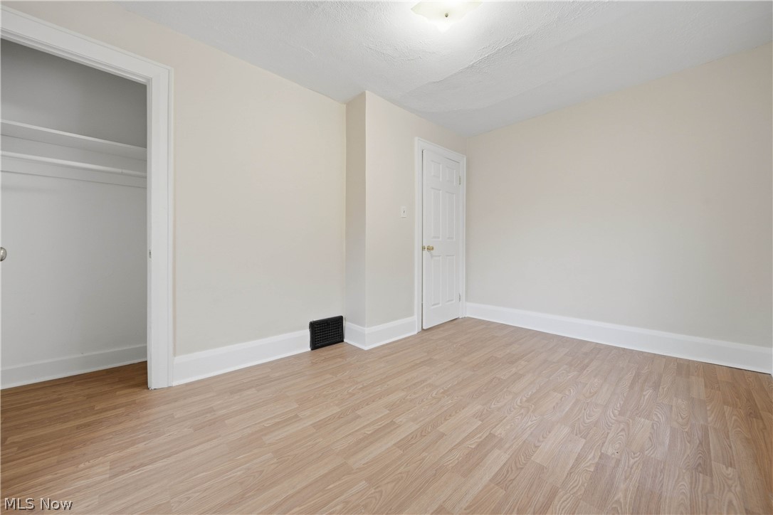 225 Cranz Place Akron, OH 44310 - Photo 24 of 34 Unfurnished bedroom featuring light wood-style flooring and a closet