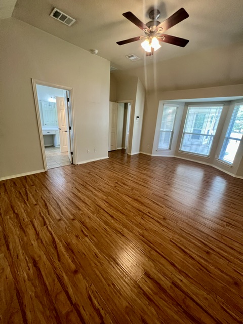 20724 Kearney Hill Road Pflugerville, TX 78660 - Photo 24 of 40 Spacious room featuring rich wood-finish flooring, a contemporary ceiling fan with integrated lighting, and a prominent bay window providing ample natural light