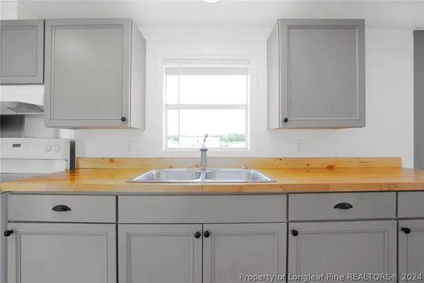 a kitchen with refrigerator and cabinets