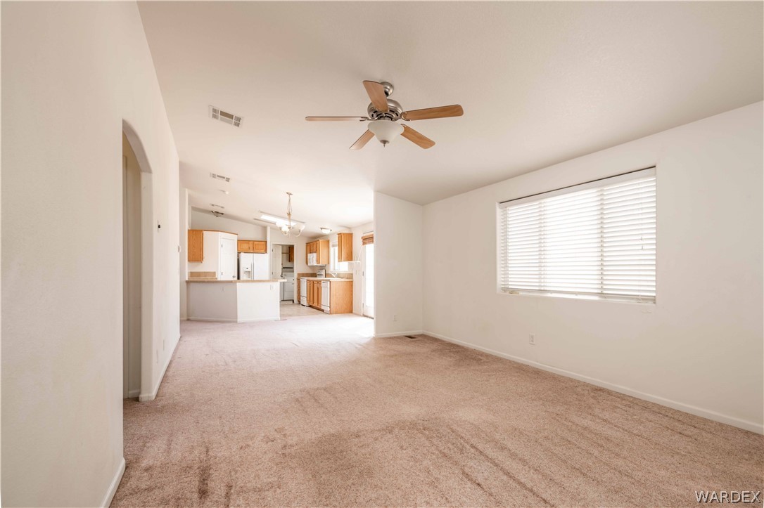 4229 Cove Road Golden Valley, AZ 86413 - Photo 11 of 36 a view of a livingroom with a chandelier fan and windows