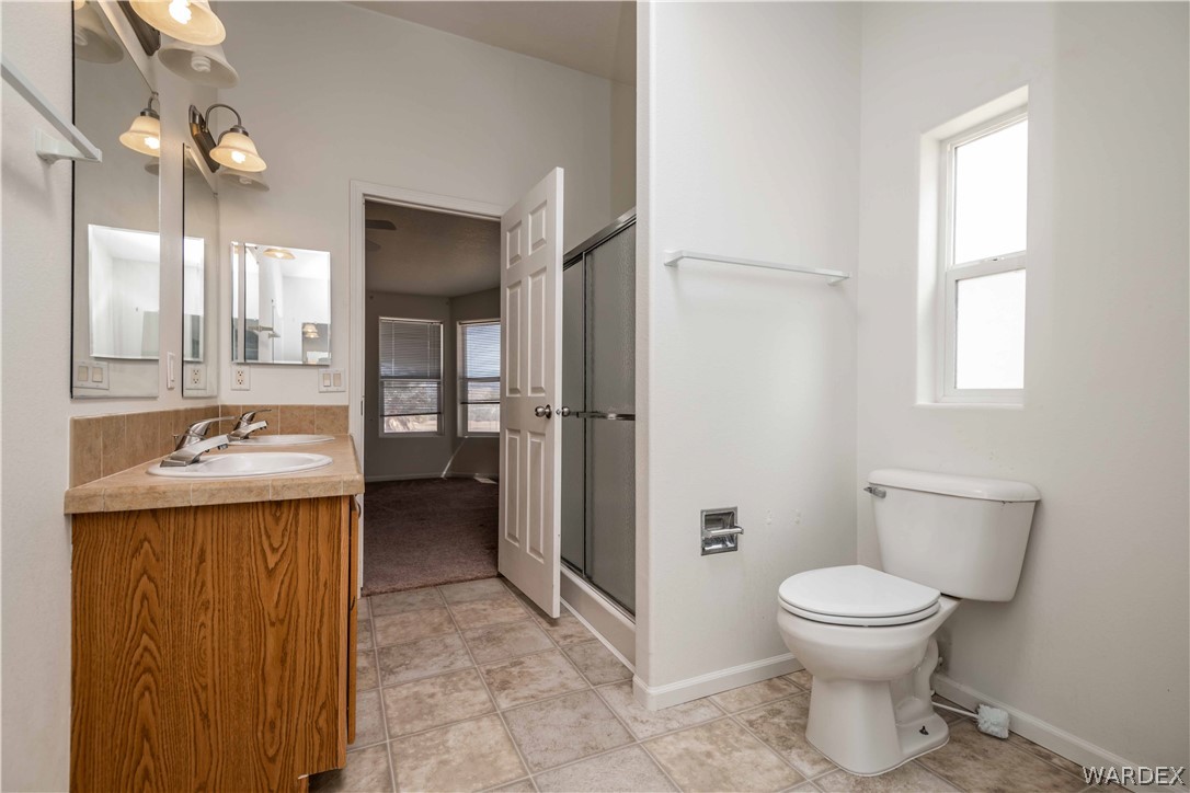 4229 Cove Road Golden Valley, AZ 86413 - Photo 17 of 36 a bathroom with a toilet sink and shower