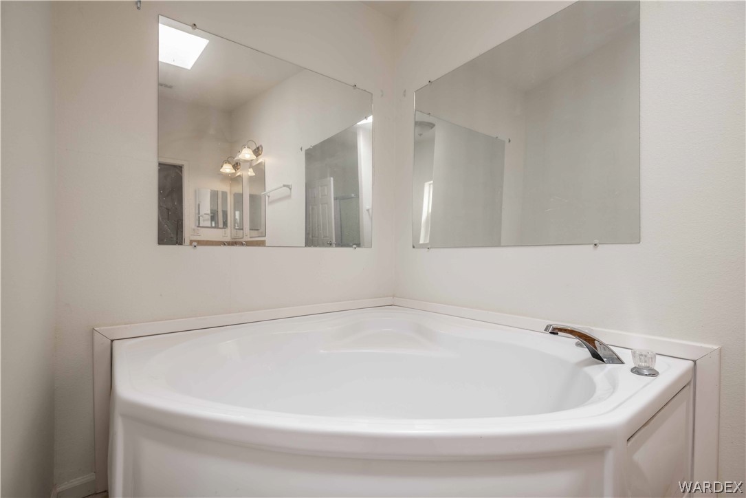 4229 Cove Road Golden Valley, AZ 86413 - Photo 19 of 36 a white bath tub sitting in a bathroom