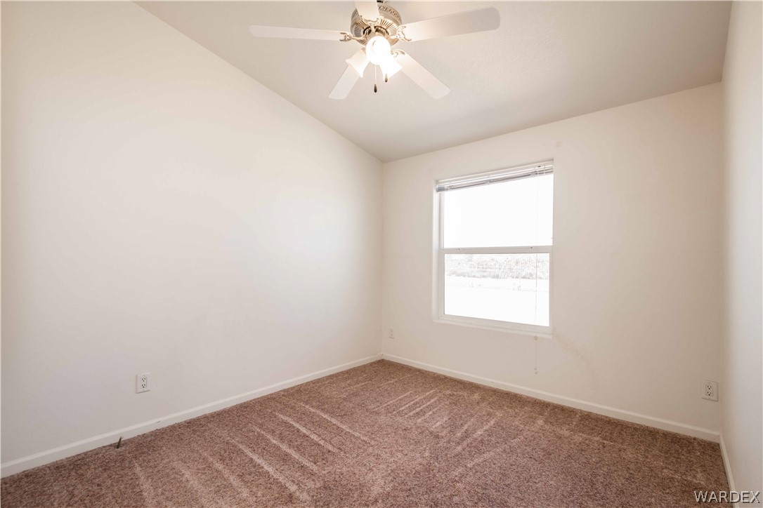 4229 Cove Road Golden Valley, AZ 86413 - Photo 20 of 36 an empty room with a window and a chandelier fan