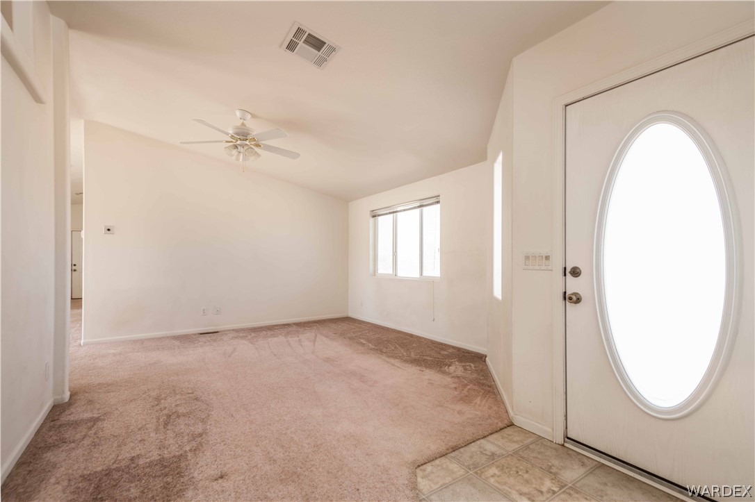 4229 Cove Road Golden Valley, AZ 86413 - Photo 3 of 36 a view of a room with wooden floor and white walls