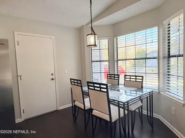 a view of a dining room with furniture window and outside view