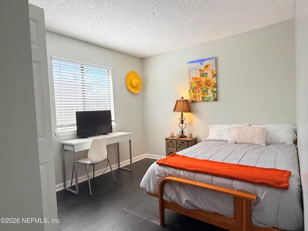 a bedroom with a bed and a desk
