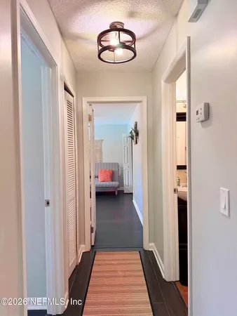 a view of a hallway view with three rooms