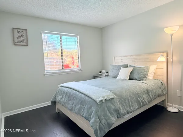 a bedroom with a bed and window