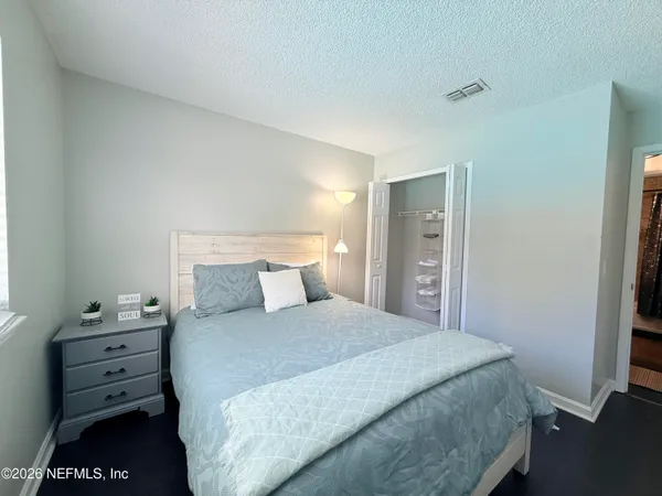 a bedroom with a bed and a closet