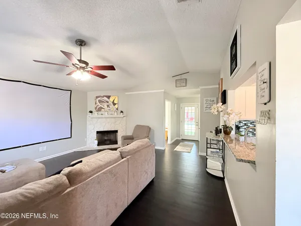 a living room with furniture fireplace and a window