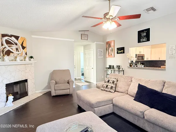 a living room with furniture and a fireplace