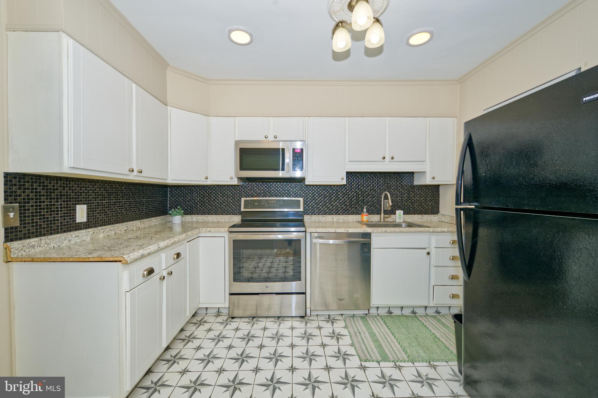 89 Cooper Road Dover, DE 19901 - Photo 17 of 32 a kitchen with a sink a stove and refrigerator