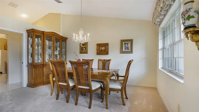 a view of a dining room with furniture and chandelier