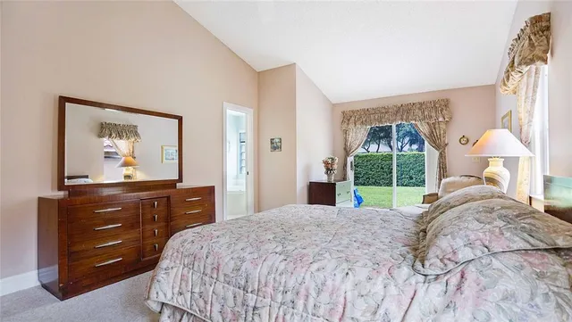 a bathroom with a tub a sink double vanity and a mirror