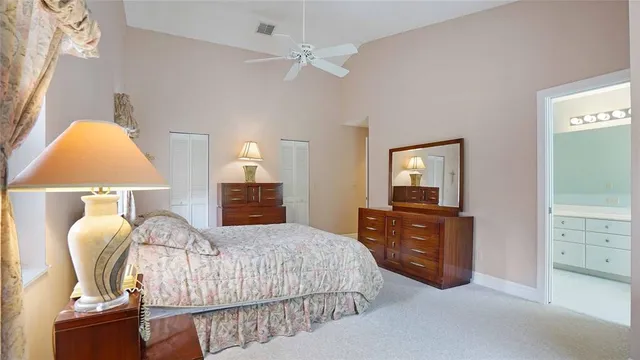 a bathroom with a granite countertop tub sink and mirror