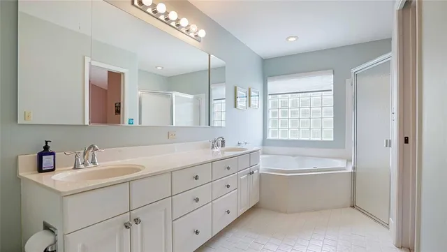 a bedroom with a bed and a potted plant